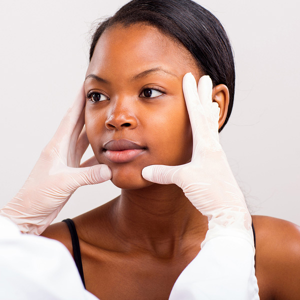 patient having her face checked to determine best skin care routine for her
