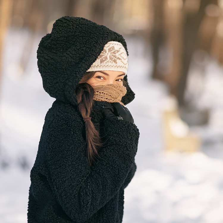 woman bundled up to protect against winter skin